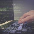 Hands typing on laptop